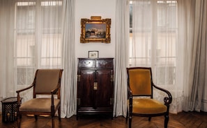 A room with two wooden chairs, a dark wooden cabinet with drawers, and a framed painting on the wall. - Charming Maître Albert 2BR/2BA near Seine, St. Germain and Notre-Dame (Paris)