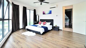 A modern bedroom with a large bed, a ceiling fan, and a view of the outdoors. - Executive 3 BR Condo, Cyberjaya (Cyberjaya)