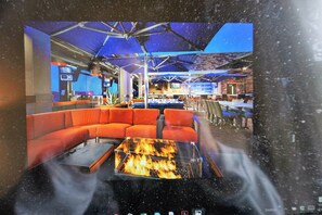 Relax in this stylish space with a cozy fire, comfortable seating, and a modern design.