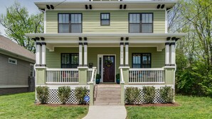 A two-story house with a front porch, a front door, and a small front yard. - Spring Discounts! Big Yard for Pets! Restaurants!BROADWAY/Downtown 1 ML TOPGOLF! (Nashville)