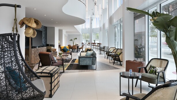 A spacious lobby with modern furniture, a large seating area, and large windows offering views of the outside. - Citadines Confluent Nantes (Nantes)