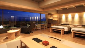 A modern hotel room with a large window, a desk, a bed, and a seating area. - Yumotokan New Hamajima (Shima)