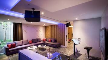 Party Suite (Consecutive night 11 pm check-out required) | Living area | Plasma TV, toys