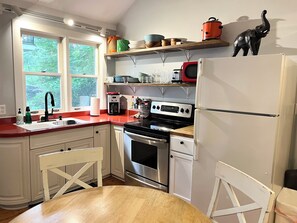 Enjoy cooking in this well-equipped kitchen with a central island, oven, and stovetop.