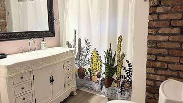 Combined shower/bathtub, hair dryer, towels, toilet paper