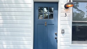 A blue door with a small window above it, a mailbox, and a house number '3' on the right. - 1 bed/1 bath, 1.5 blocks to beach/town, dog friendly, fenced yard (Union Pier)