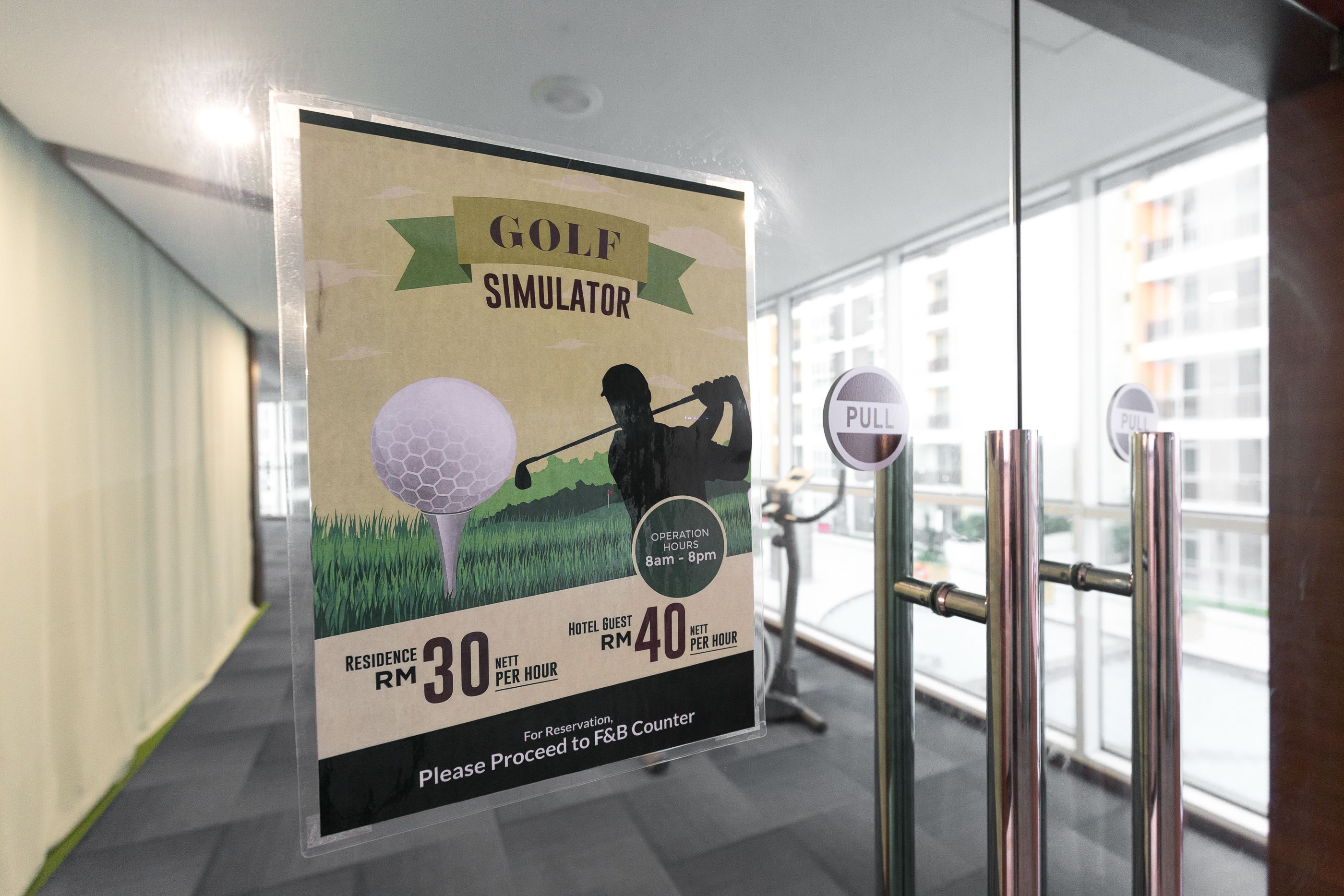 A sign for a golf simulator with operation hours and pricing details.