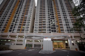 A high-rise residential building with multiple balconies and a central entrance. - Taman Daya Homybed Homestay (Johor Bahru)