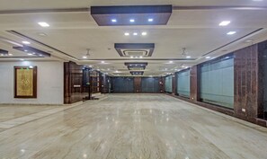 A spacious, well-lit lobby with a marble floor, recessed lighting, and a large framed artwork on the left wall. - Treebo Sreema Saltlake Near City Centre Mall (Bidhannagar)