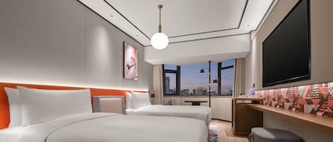A modern hotel room with two beds, a large TV, and a city view.