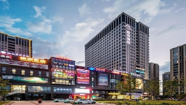 A modern hotel building with multiple floors and a prominent sign. - Atour Hotel Binjiang Binwen Road Hangzhou (Hangzhou)