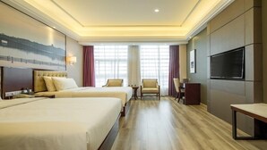A hotel room with two beds, a TV, a desk, and a chair. - Atour Hotel Binjiang Binwen Road Hangzhou (Hangzhou)