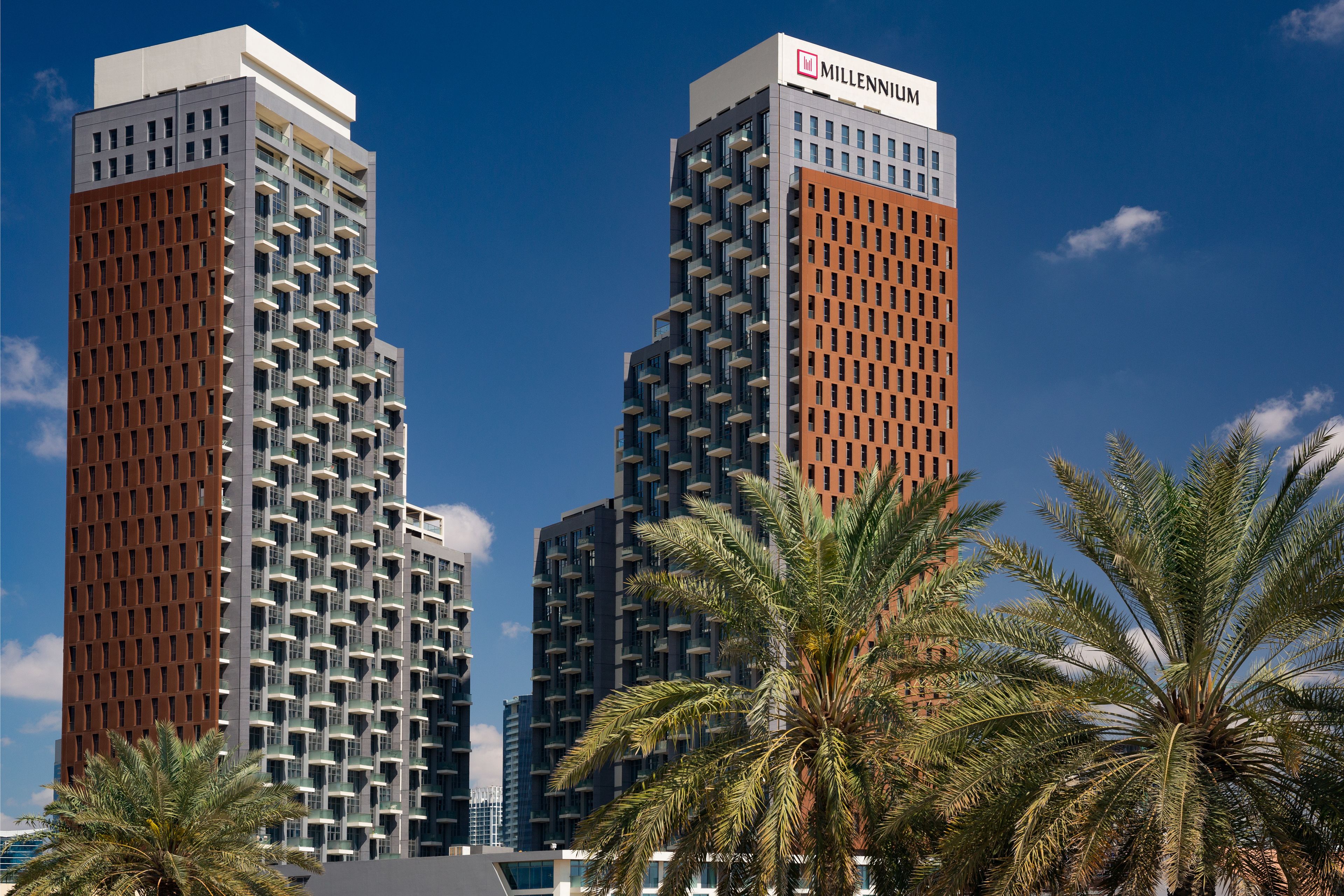 Two high-rise buildings with balconies, one labeled "Millennium."