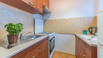 Apartment | Private kitchen | Full-size fridge, stovetop, electric kettle, cookware/dishes/utensils