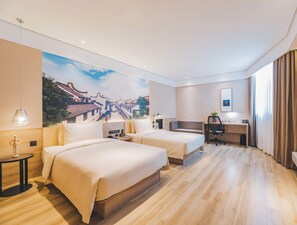 A hotel room with two beds, a desk, a chair, a lamp, and a large wall mural. - Atour Hotel Shengtai West Road South Railway Station Nanjing (Nanjing)