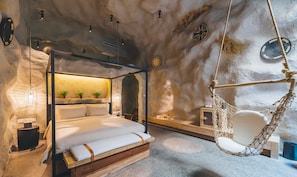 A bedroom with a four-poster bed, a hanging chair, and a small shelf with decorative items. - Atour Hotel Wujiang Suzhou (Suzhou)
