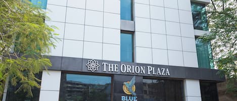 Home to a commercial space and a prominent sign, The Orion Plaza offers a unique urban experience.