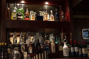 A bar with multiple shelves of liquor bottles.