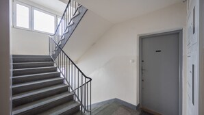 A staircase with metal railings leading to a door. - Riverside Comfort Studio (Warsaw)