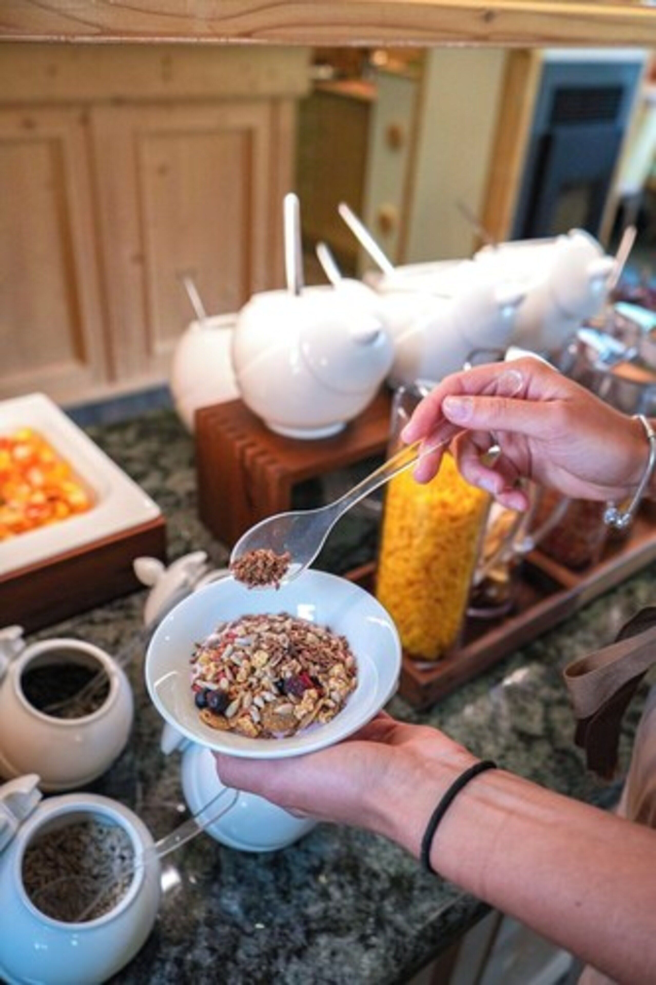 A buffet setup with various food items and tea options.