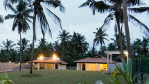A resort with two main buildings, a covered outdoor area, and a well-maintained lawn. - Ayana Beach Resort (Negombo)
