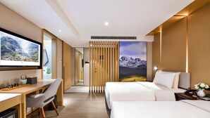 A modern hotel room with a large bed, a desk, and a TV displaying a welcome message. - Atour Hotel Hongpailou Chengdu (Chengdu)