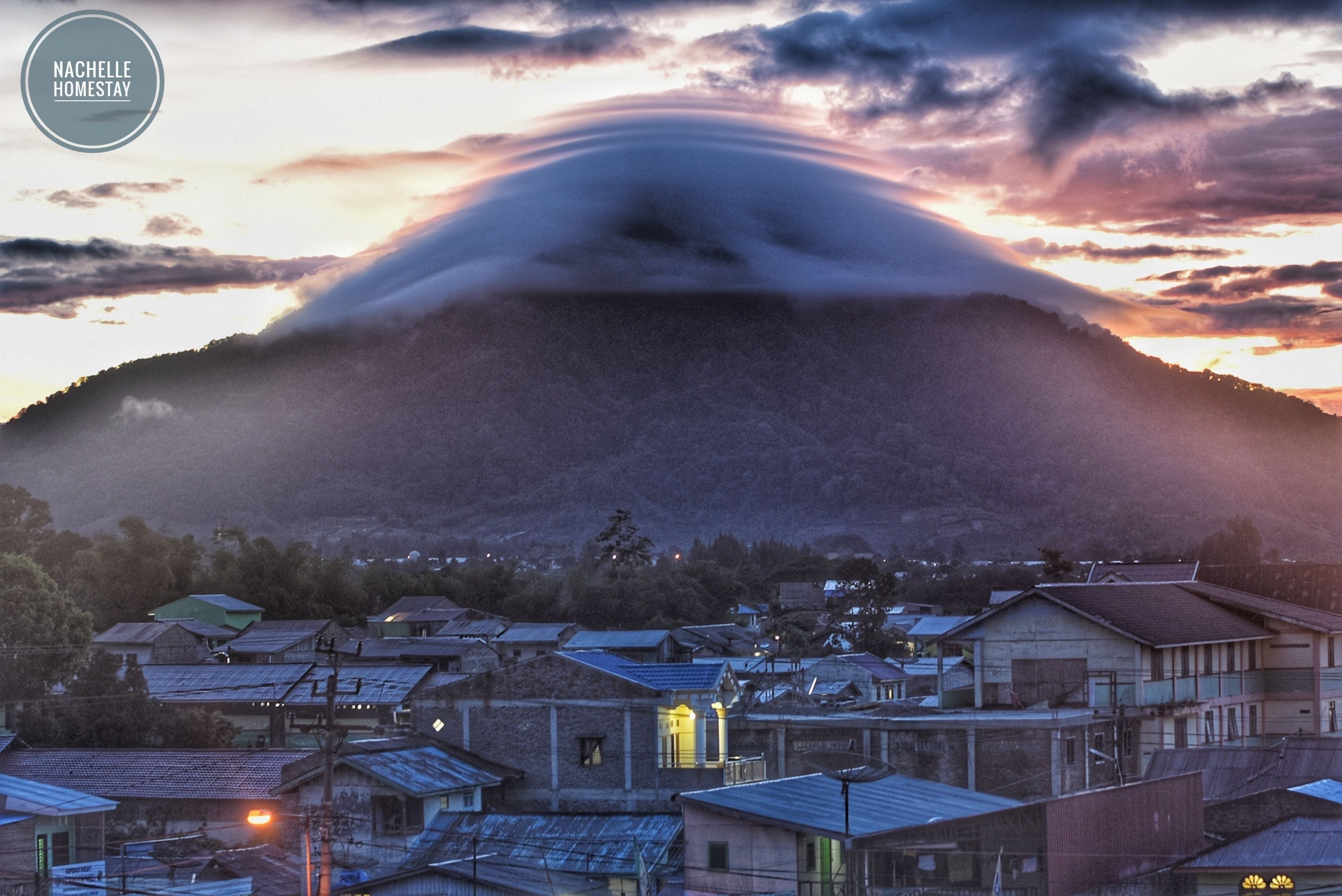 A town with a prominent mountain in the background.