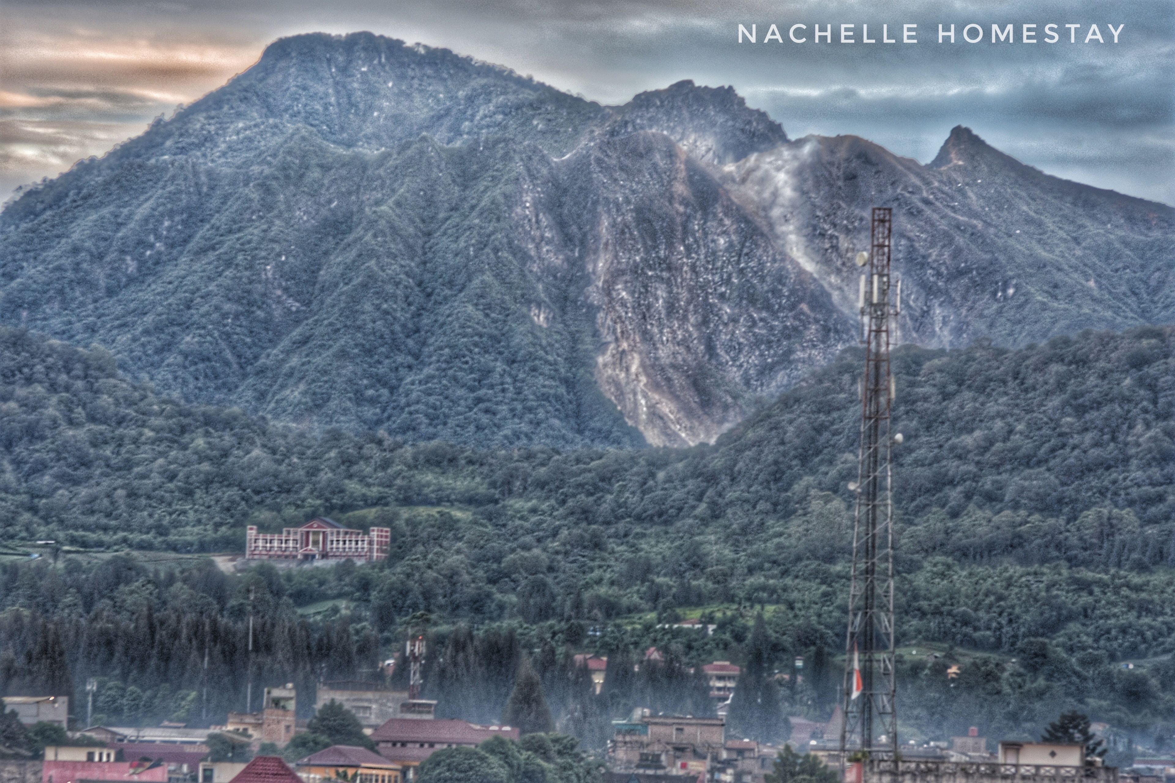 A mountainous landscape with a prominent tower structure.