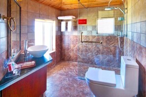 A modern bathroom with a marble floor, a white sink with a large bowl, a glass shower enclosure, and a toilet. - Tengchong Longju Garden Villa Hotel (Tengchong)