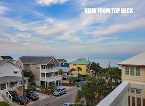 Stroll along the quiet coastal street, taking in the charm of these two-story homes with inviting balconies.