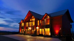 A large, multi-story building with a prominent entrance and large windows, likely a hotel or resort.