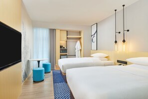 A hotel room with two beds, a TV, a desk with a chair, and a bathroom visible through an open door. - Fairfield by Marriott Changsha Tianxin (Changsha)