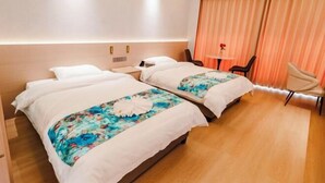 A hotel room with two beds, a desk, a chair, and a large window with curtains. - Lvzhiyun International Hotel (Liuyang)