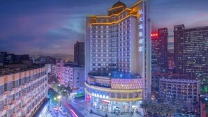A high-rise hotel with multiple floors, a prominent dome on the top, and a well-lit facade. - Kailong Hot Spring Hotel (CHENZHOU)