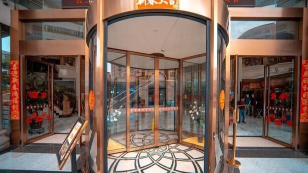 A revolving door entrance with glass panels and a geometric floor pattern. - Kailong Hot Spring Hotel (CHENZHOU)