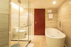 A modern bathroom with a glass-enclosed shower, a toilet, and a freestanding bathtub. - Huatian Hotel (Xiangtan)