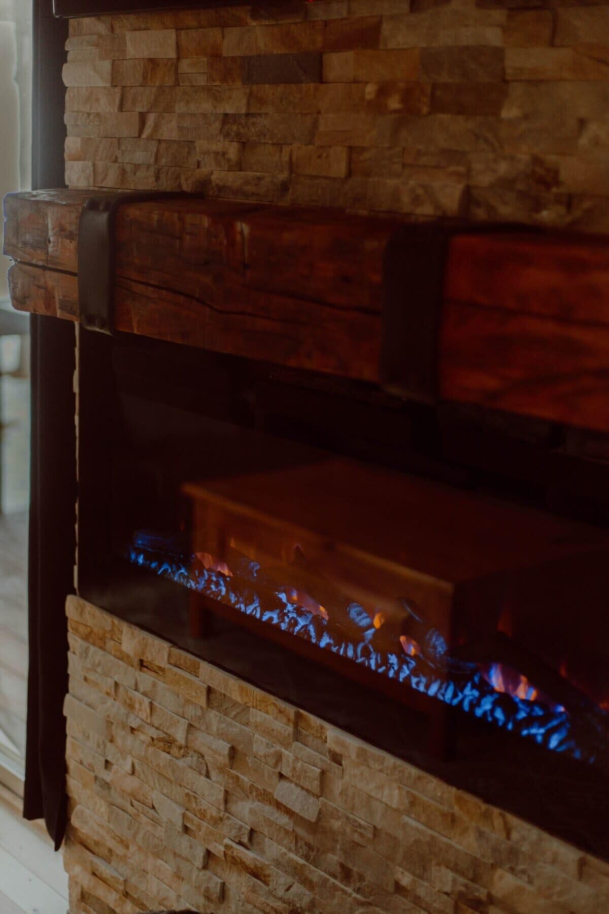 A stone fireplace with a visible fire.