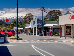 A street view with a Bayleys store, a Ruapehu Chalet Rentals sign, and a NWT sign. - Ohakune TOP 10 Holiday Park (Ohakune)