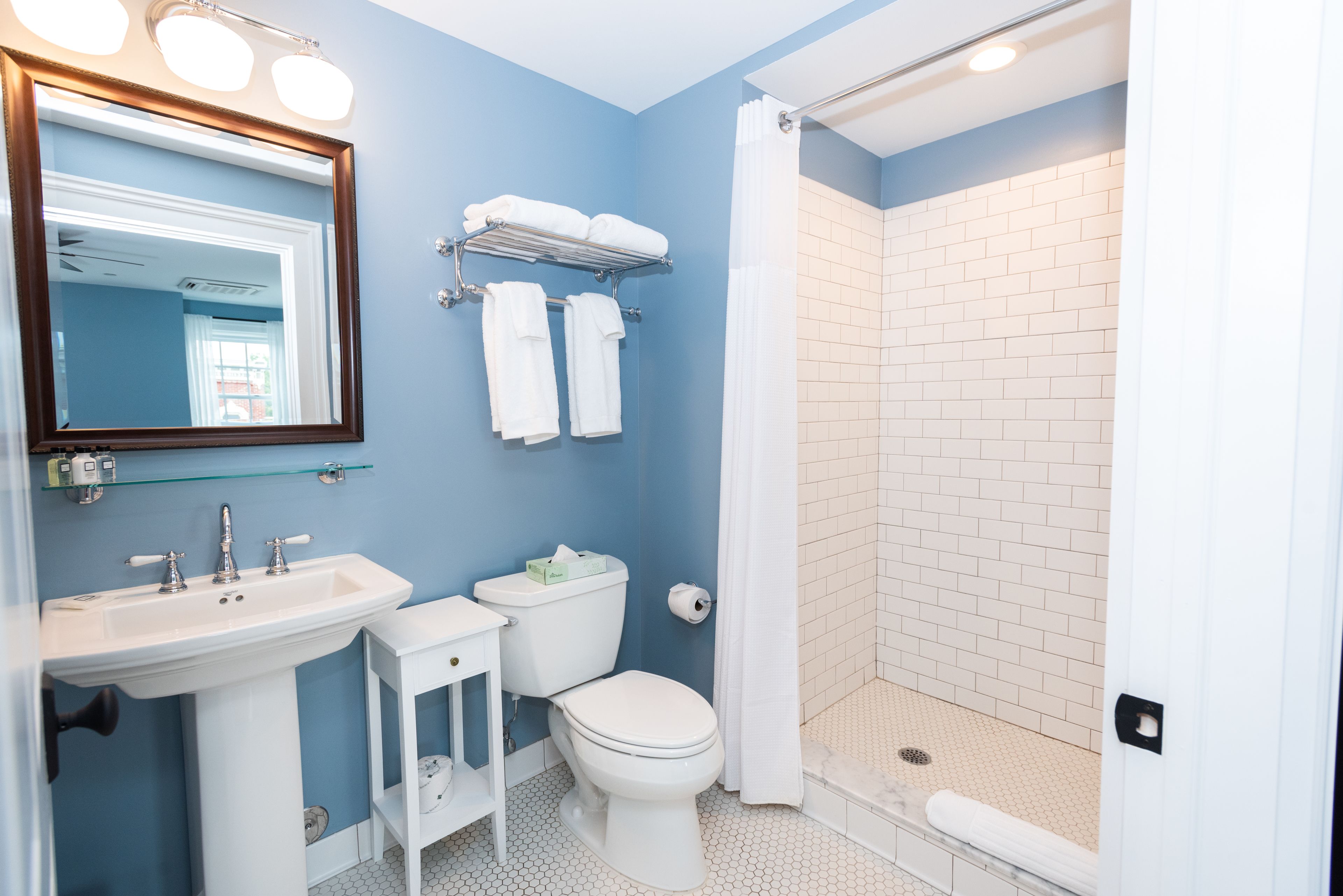 A bathroom with a sink, toilet, and shower.