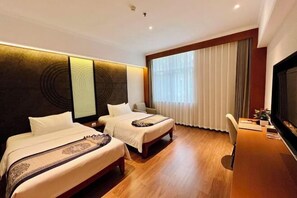 A hotel room with two beds, a desk, a television, and a large window with curtains. - Fengleyuan Hotel (Zhengzhou)
