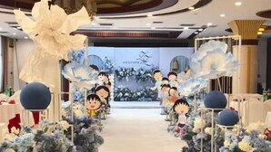 A hotel corridor with floral decorations and cartoon character cutouts. - Fengleyuan Hotel (Zhengzhou)