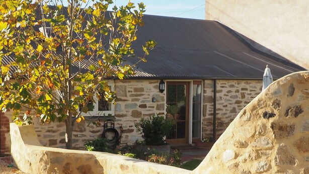 A stone building with a sloped roof, a door, and a window. - Cobblers Cottage B & B Accommodation (Willunga)