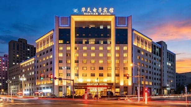 A multi-story hotel with a prominent entrance and signage.