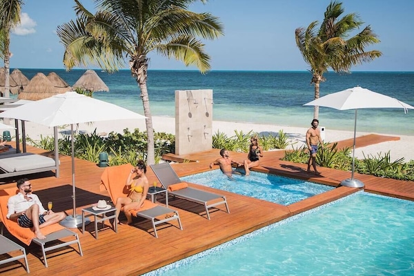 Beach Club with Outdoor Showers, Jacuzzi, and plenty of lounge chairs