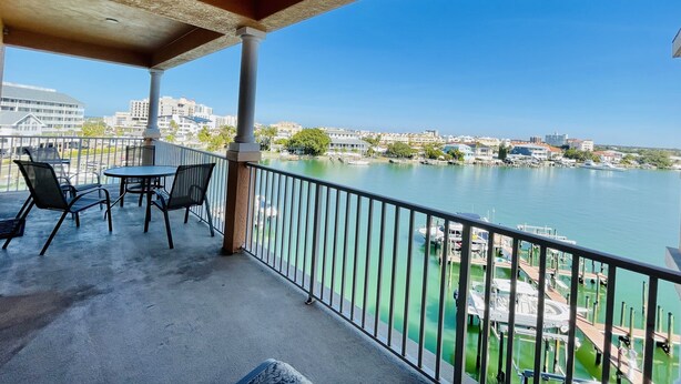 A balcony with a view of a marina and cityscape. - FABULOUS SPRING SALE! 🌸🌼at  Luxurious Waterfront  condo in Clearwater Beach  (Clearwater Beach)