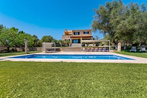 A two-story house with a swimming pool, outdoor seating, and a well-maintained lawn. - Bassa Seca by dracmallorca (Santanyi)