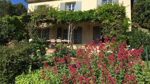 A two-story building with a tiled roof and a balcony. - Beautiful house with private heated infinity pool 16 km from Uzes (Connaux)