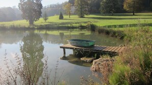 A serene lakeside scene with a wooden dock and a boat. - 3 of cottage oak: Nestled in a clearing in the middle of Vexin regional park (Chambly)