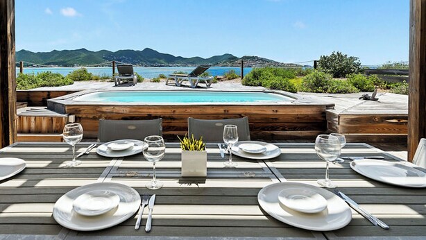 An outdoor dining area with a pool and a view of the sea and mountains. - Oceanfront amazing 2 BR Villa - 2 min from the beach (Beacon Hill)