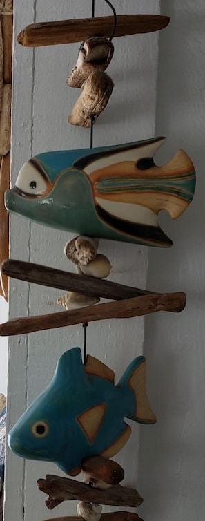 Decorative fish sculptures adorn the wall, arranged in a visually appealing display.